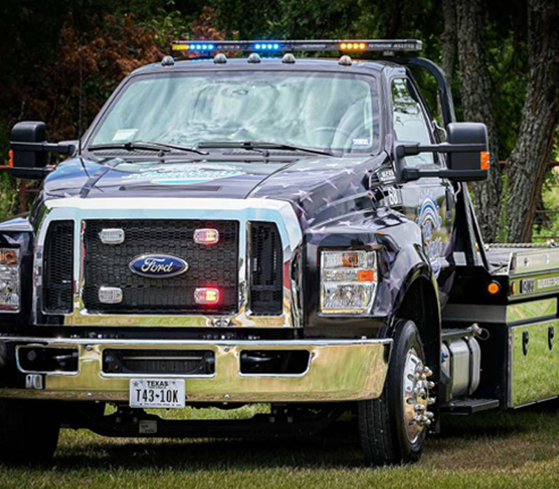 Flatbed-Tow-Truck-Sitting-in-a-Field-in-Justin-Texas-All-American-Towing Flatbed Tow Truck Sitting in a field in Justin Texas